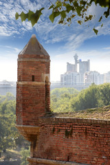 The walls of the Kalemegdan fortress and watchtower with city skyline in the background, Belgrade, Serbia