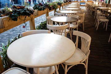 Round tables and chairs at an open-air restaurant