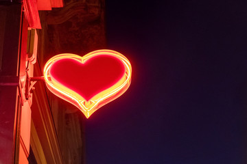 Bright red heart shaped illuminated neon sign