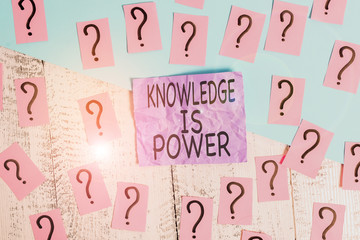 Text sign showing Knowledge Is Power. Business photo showcasing skills acquired through experience and education Scribbled and crumbling papers with thick cardboard above wooden table
