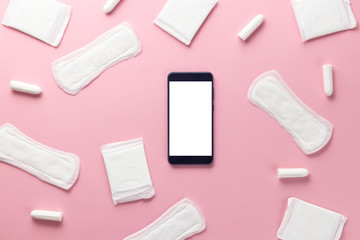 Tampons, feminine sanitary pads and gadget on a pink background. Hygienic care on critical days. menstrual cycle. Caring for women's health. Monthly protection. Flat lay, top view, copy space
