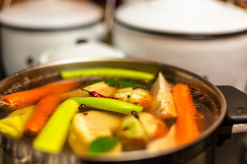 Fresh homemade chicken soup in the kitchen