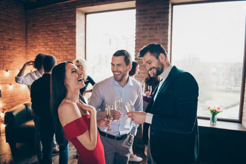 Photo of cheerful positive nice pretty girl laughing with other men joking at her holding glasses of alcohol wearing formally