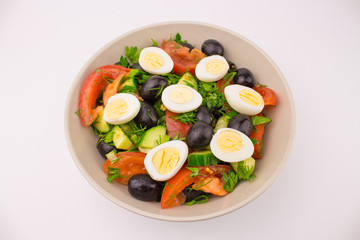 Salad with quail eggs tomato cucumber olive greens. Mix of fresh vegetables, Mediterranean cuisine. Plate with egg and vegetable salad