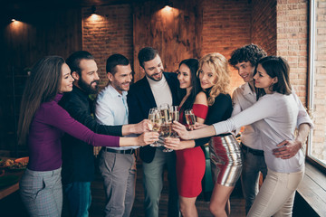 Photo of positive beautiful corporate people clinking glasses of alcohol celebrating beginning of vacation in formalwear