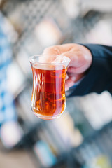 Hand holds a Cup of Turkish tea