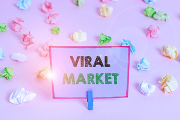 Writing note showing Viral Market. Business concept for the information about a product spreads between showing Colored crumpled papers empty reminder pink floor background clothespin