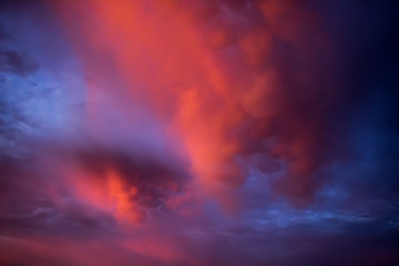 Unusual pink-purple mammatus clouds at sunset. Blurred image for backgrounds.