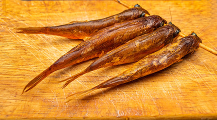 Dried mullet on a wooden Board on the table. Fish and seafood cuisine. Tasty snack.