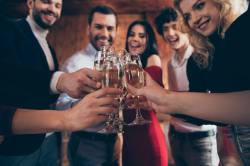 Cropped close-up view of nice attractive trendy elegant cheerful cheery glad positive guys people celebrating clinking glasses congrats at modern industrial loft brick wood style interior indoors