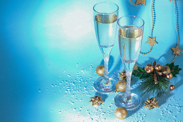 Christmas mood. Glasses with champagne. New Year. Christmas-tree decorations, coniferous branches....