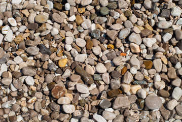 Texture of marine stones eroded by the waters of the sea of various colors and shapes, taken on the beach of Nerano