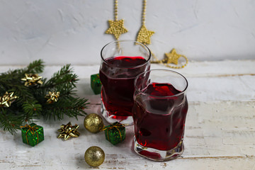 Christmas red wine mulled wine with spices and on a dark background. Around the white snow. New Year. Christmas decorations, cinnamon sticks. Copy space. 