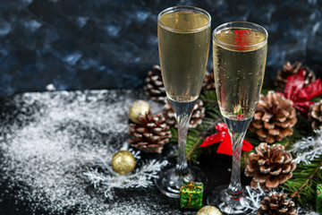 Christmas mood. Glasses with champagne. New Year. Christmas-tree decorations, coniferous branches....