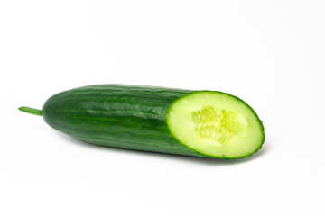 Ripe green long cucumber in a cut on a white background
