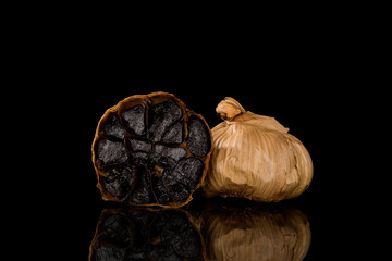 Black garlic on dark background.