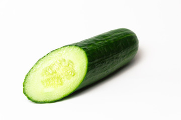 Ripe green long cucumber in a cut on a white background
