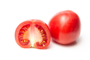 Ripe pink cutaway tomato on a white background