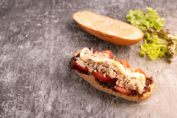 Sandwich Tuna with filling from lettuce, tomato with whole wheat bread.