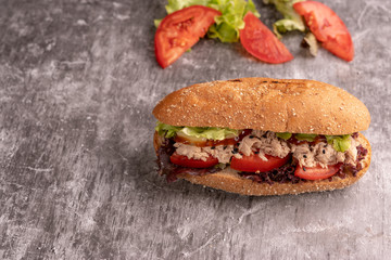 Sandwich Tuna with filling from lettuce, tomato with whole wheat bread.