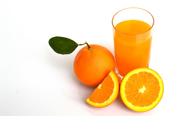 glass of orange juice and oranges isolated on white