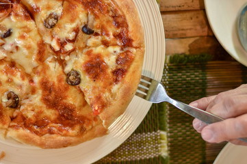 Fresh and hot from oven mushroom pizza being served on the table.
