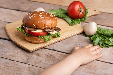 Cheese and mushroom burger, kids hands