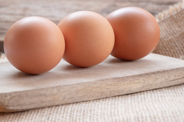 Close up chicken eggs with wooden background