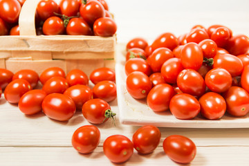 CHERY TOMATOES ON BOARDS ON WHITE BACKGROUND