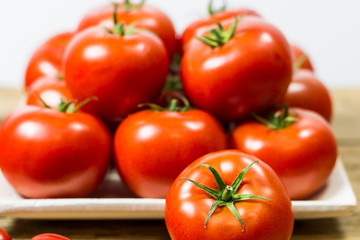 CHERY TOMATOES ON BOARDS ON WHITE BACKGROUND