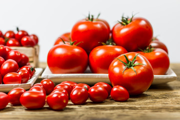 CHERY TOMATOES ON BOARDS ON WHITE BACKGROUND