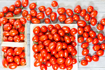 CHERY TOMATOES ON BOARDS ON WHITE BACKGROUND