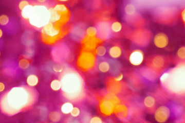 Beautiful multicolored blurred bokeh lights holiday glitter background for Christmas New Year Birthday celebration with golden sparklers red pink purple glow flashes