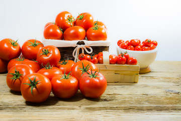 CHERY TOMATOES ON BOARDS WITH SPICES ON WHITE BACKGROUND