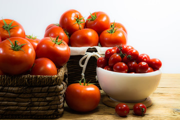 CHERY TOMATOES ON BOARDS WITH SPICES ON WHITE BACKGROUND
