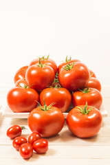 CHERY TOMATOES ON BOARDS WITH SPICES ON WHITE BACKGROUND
