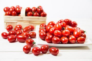 CHERY TOMATOES ON BOARDS WITH SPICES ON WHITE BACKGROUND