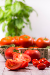 CHERY TOMATOES ON BOARDS WITH SPICES ON WHITE BACKGROUND
