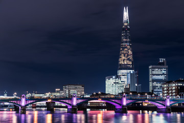Fototapeta na wymiar Modern London city skyline on River Thames with shard building and illuminated river lights
