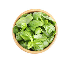 Fresh green basil leaves in wooden bowl isolated on white, top view