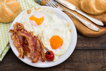 Bacon and eggs for breakfast on the plate