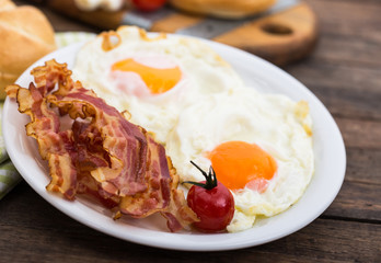Bacon and eggs for breakfast on the plate