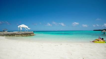 Maldives white sand beach with turquoise water and blue sky
