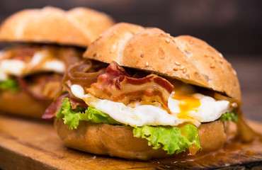 Bacon and egg sandwiches with onions and lettuce