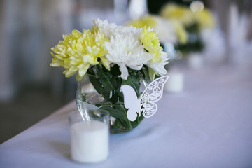 bouquet in a glass vase on a wedding table