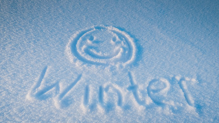 Obraz na płótnie Canvas smiley face, inscription on the snow