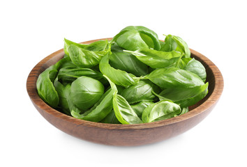 Fresh basil leaves in wooden bowl isolated on white