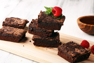 chocolate brownie cake dessert with raspberries and spices on a wooden background.