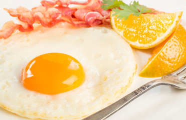 Breakfast plate with fried eggs and bacon