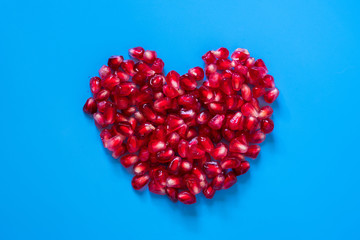 ripe and delicious pomegranate on blue